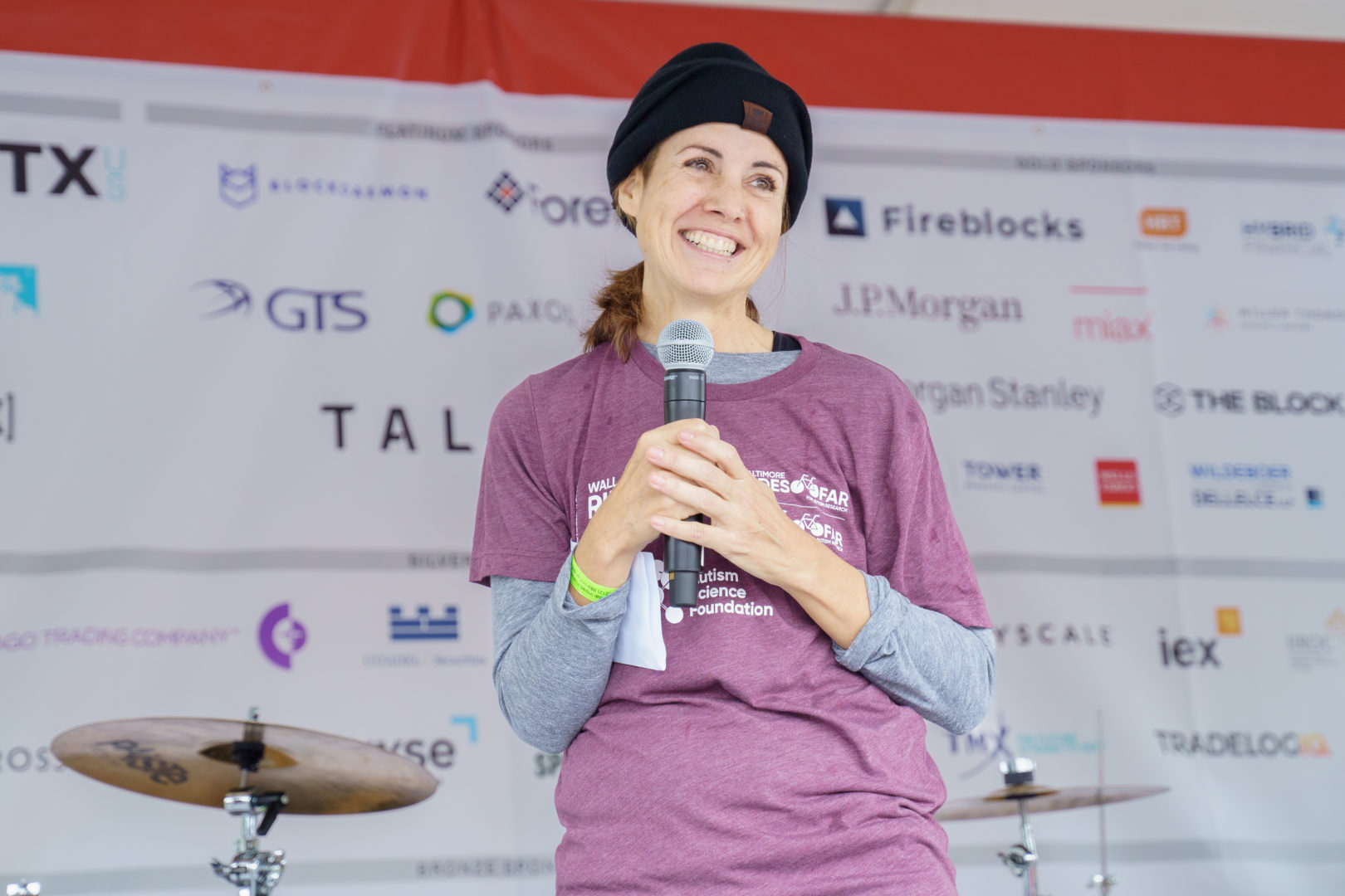Erin Lopes smiles onstage at the 2022 Rides FAR event in New York